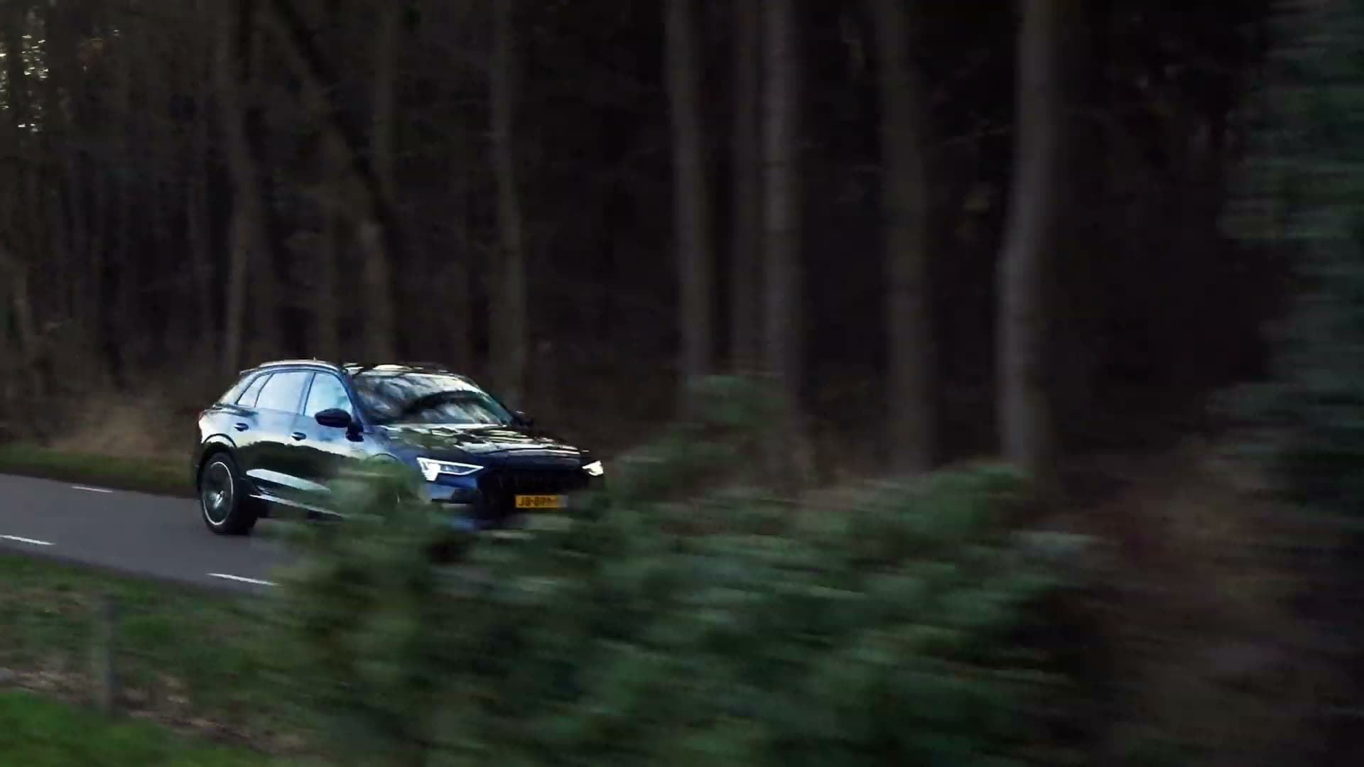 Automotive aerial cinematography of a vehicle moving through European landscape